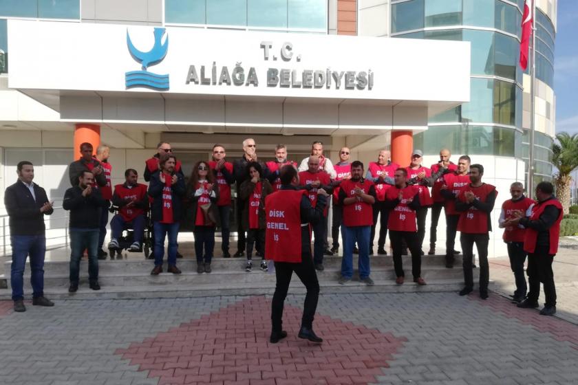 İşten atılan Aliağa Belediyesi işçileri, topladıkları imzaları teslim etmelerinin ardından Belediye binası önünde açıklama yaparken