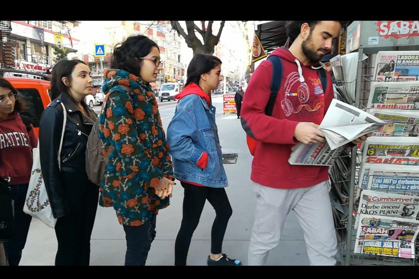 Evrensel readers are buying newspaper from kiosk.