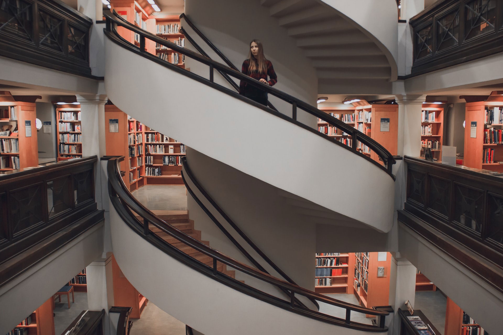 Helsinki'de bir kütüphanenin merdivenlerinde duran bir kadın