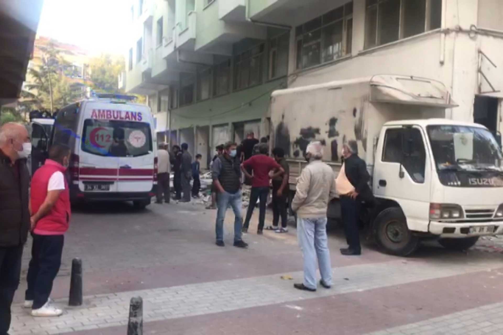 Büyükçekmece'de iş kazası meydana gelen bina (sağda), ambulans (solda)